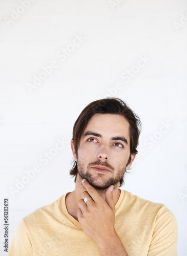 Idea mockup, face and man thinking, pensive and focus on contemplating problem solving plan. Studio marketing space, advertising mock up and model product placement isolated on white background wall