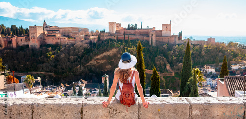 Leinwand Poster Woman tourist looking at Ancient arabic fortress Alhambra- Granada in Spain