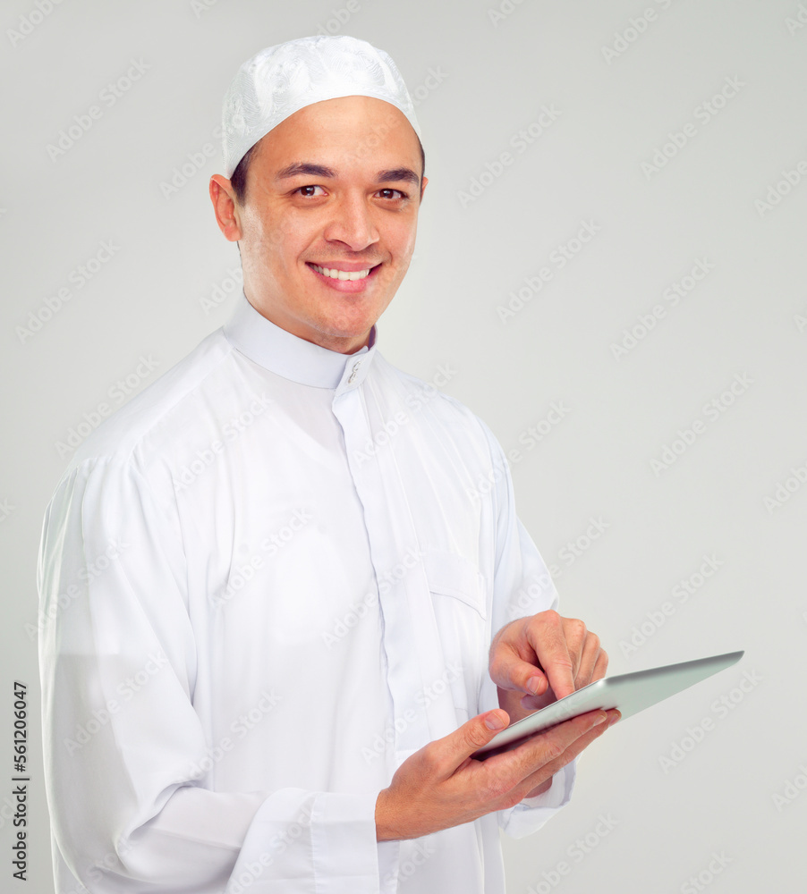 Islamic man, tablet and happy portrait for Muslim reading, education or culture standing in white background. Young person, smile and digital tech learning for religious mindset isolated in studio Islamic man, tablet and happy portrait for Muslim reading, education or culture standing in white background. Young person, smile and digital tech learning for religious mindset isolated in studio