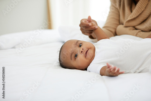 cute African baby lying on the bedroom