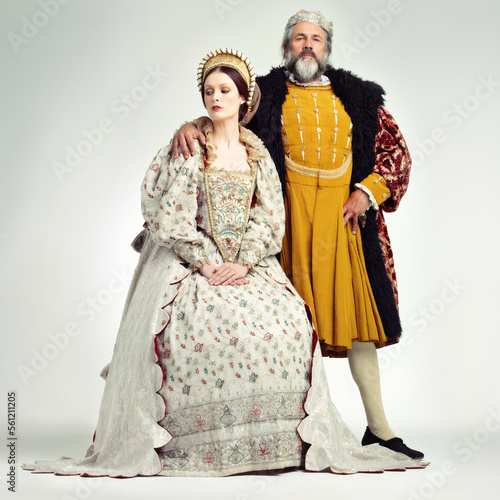 King, queen and crown with a couple in studio on a gray background during the renaissance or victorian period. Royalty, history and vintage with a man and woman monarch, leader or ruler of a kingdom