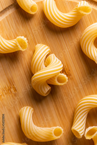 Raw pasta on a wooden board photo