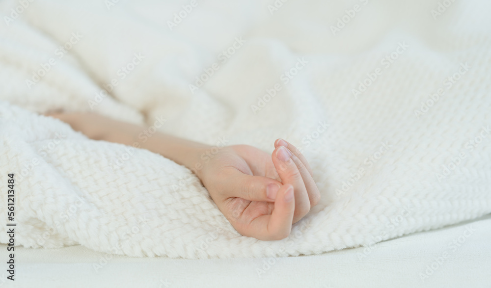 The woman's hand in bed