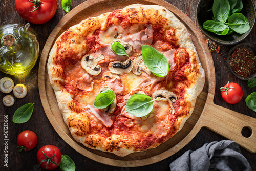 Capricciosa pizza with cheese, ham and mushrooms. Italian cuisine.