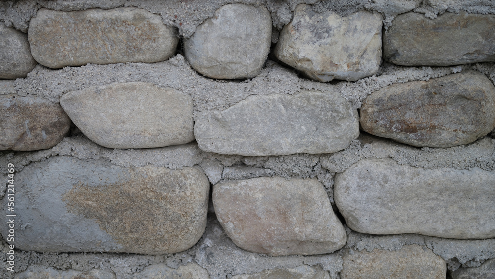 Neatly stacked rough cut stone wall seamless texture background Neatly stacked rough cut stone wall seamless texture background