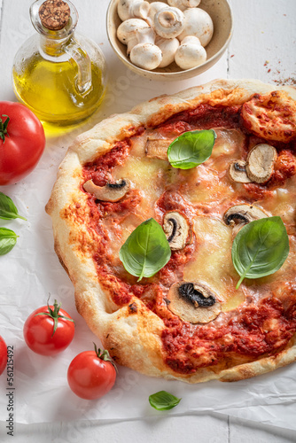 Fresh and aromatic pizza made of mushrooms and basil.