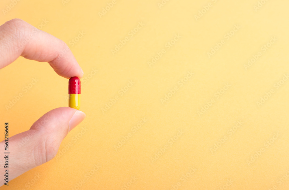 Hand holding a piece of pill with copy space Hand holding a piece of pill with copy space