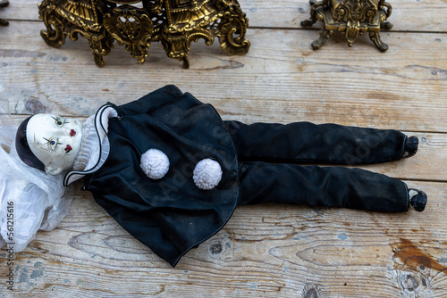 Billede på lærred A hundred-year-old vintage rag doll Pierrot lies on the table