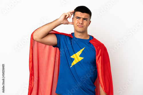 Super Hero over isolated white background having doubts and with confuse face expression