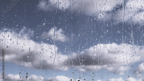 Wallpaper Mural Rain Drops Flow Down Glass Against a Background of Moving Clouds and Grey Sky. Time-lapse. Slow-moving cumulus clouds. Rainy weather. Streams of water flow down the window on glass. Meteorology. Torontodigital.ca