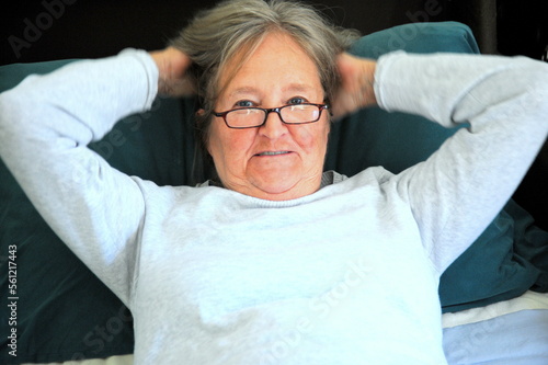 Mature female senior relaxing in bed.