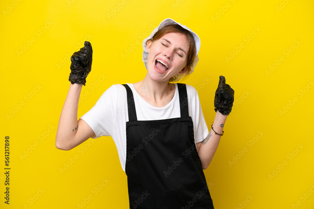 Young English fisherwoman isolated on yellow background celebrating a victory Young English fisherwoman isolated on yellow background celebrating a victory
