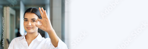 Fotografía Happy smiling friendly south asian, Indian woman office worker pointing approvin