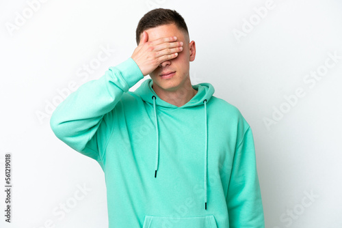 Young brazilian man isolated on white background covering eyes by hands. Do not want to see something © luismolinero