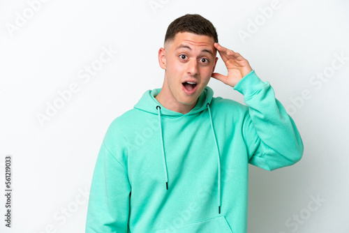 Young brazilian man isolated on white background has realized something and intending the solution © luismolinero