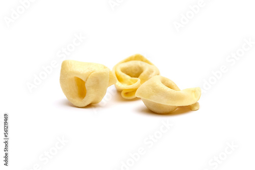 Tortellini stuffed pasta isolated on white background, closeup. Tortellini with raw prosciutto. Italian food