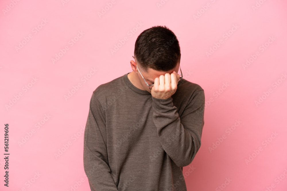 Young Brazilian man isolated on pink background with headache Young Brazilian man isolated on pink background with headache