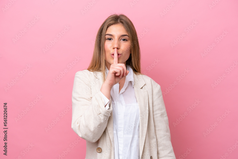 Young caucasian woman isolated on pink bakcground showing a sign of silence gesture putting finger in mouth Young caucasian woman isolated on pink bakcground showing a sign of silence gesture putting finger in mouth