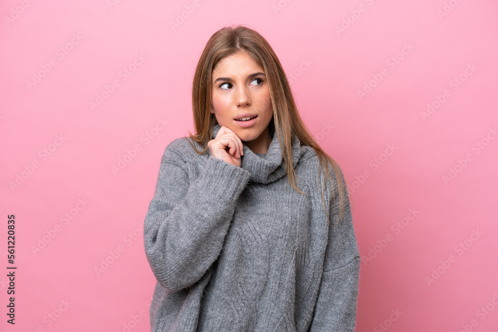 Young caucasian woman isolated on pink bakcground having doubts and thinking Young caucasian woman isolated on pink bakcground having doubts and thinking