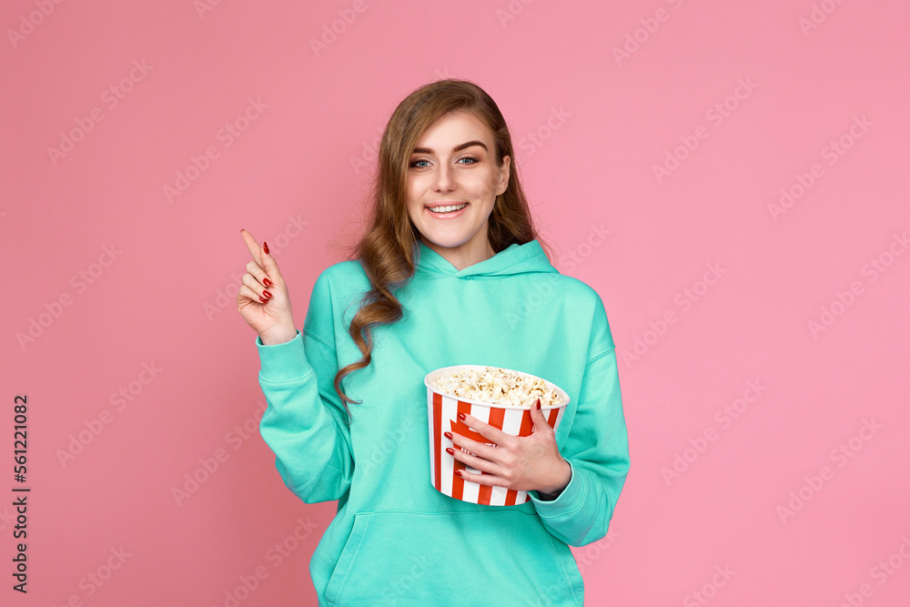 woman in sweatshirt watching movie film, eating popcorn woman in sweatshirt watching movie film, eating popcorn