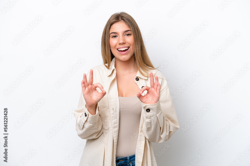 Young caucasian woman isolated on white bakcground showing ok sign with two hands