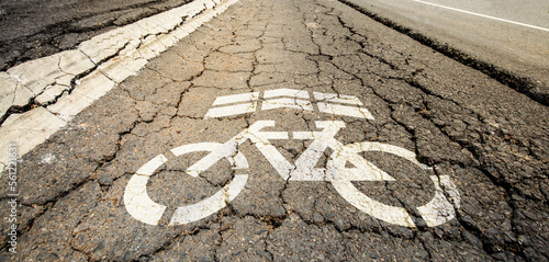 White bicycle sign lane on crack street road