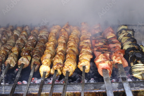 BBQ Grills - Beef and Chicken Skewered Shish Kebabs with Onions and Tomatoes Cooking Premium Images