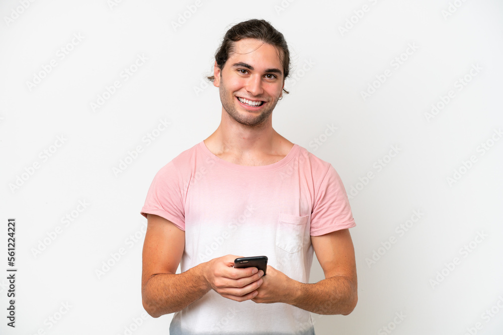 Caucasian handsome man isolated on white background sending a message with the mobile Caucasian handsome man isolated on white background sending a message with the mobile