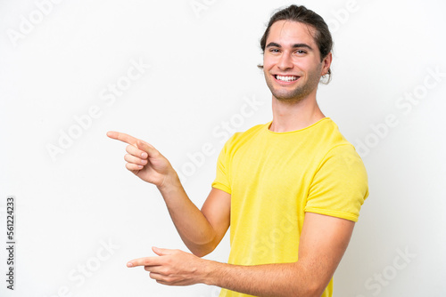 Caucasian handsome man isolated on white background pointing finger to the side and presenting a product