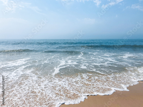 calm blue shallow waves on the beach