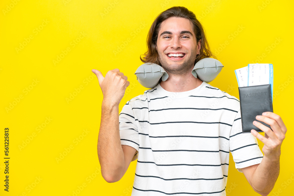 handsome Man with Inflatable Travel Pillow pointing to the side to present a product handsome Man with Inflatable Travel Pillow pointing to the side to present a product