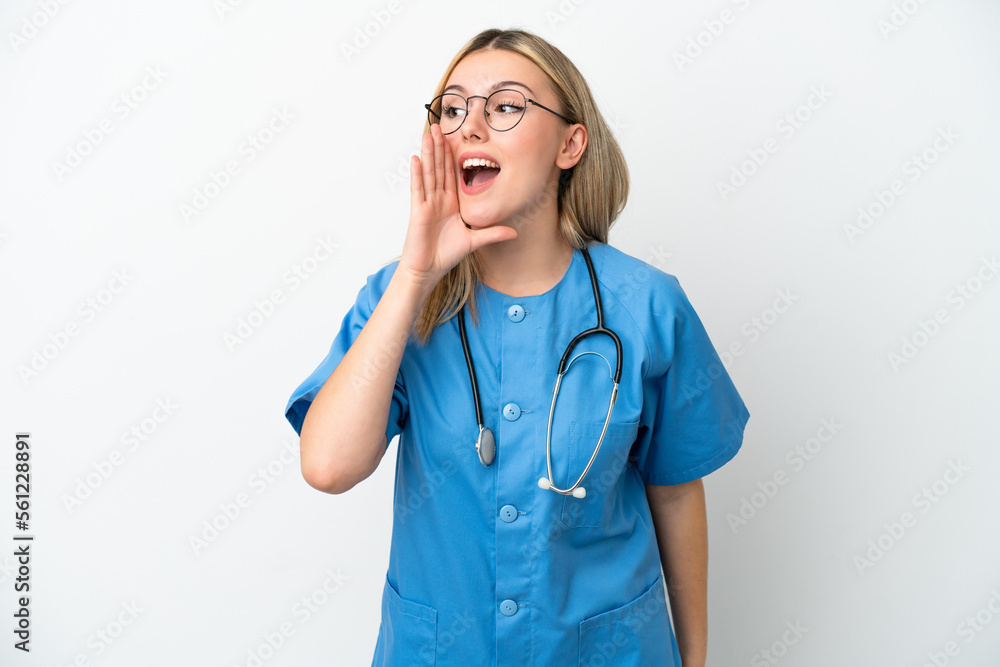 Young surgeon doctor woman isolated on white background shouting with mouth wide open to the side Young surgeon doctor woman isolated on white background shouting with mouth wide open to the side