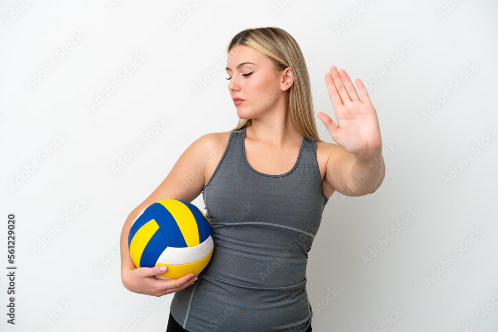 Young caucasian woman playing volleyball isolated on white background making stop gesture and disappointed