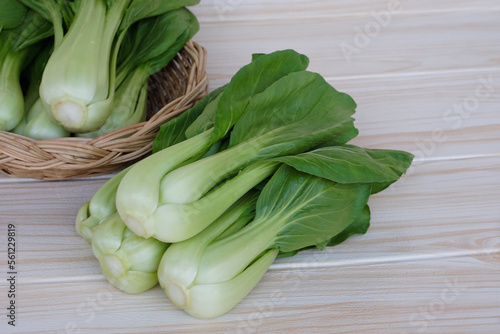 Fresh Bok Choy or Pak Choi or Chinese cabbage on wooden background and in basket for cooking. Concept, Organic vegetables. Healthy food. High fibers and vitamins.      photo