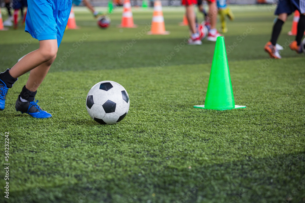 Boys Soccer ball tactics on grass field with cone Boys Soccer ball tactics on grass field with cone