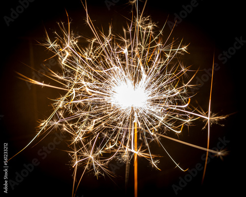 Burning sparkler fireworks against dark background. 