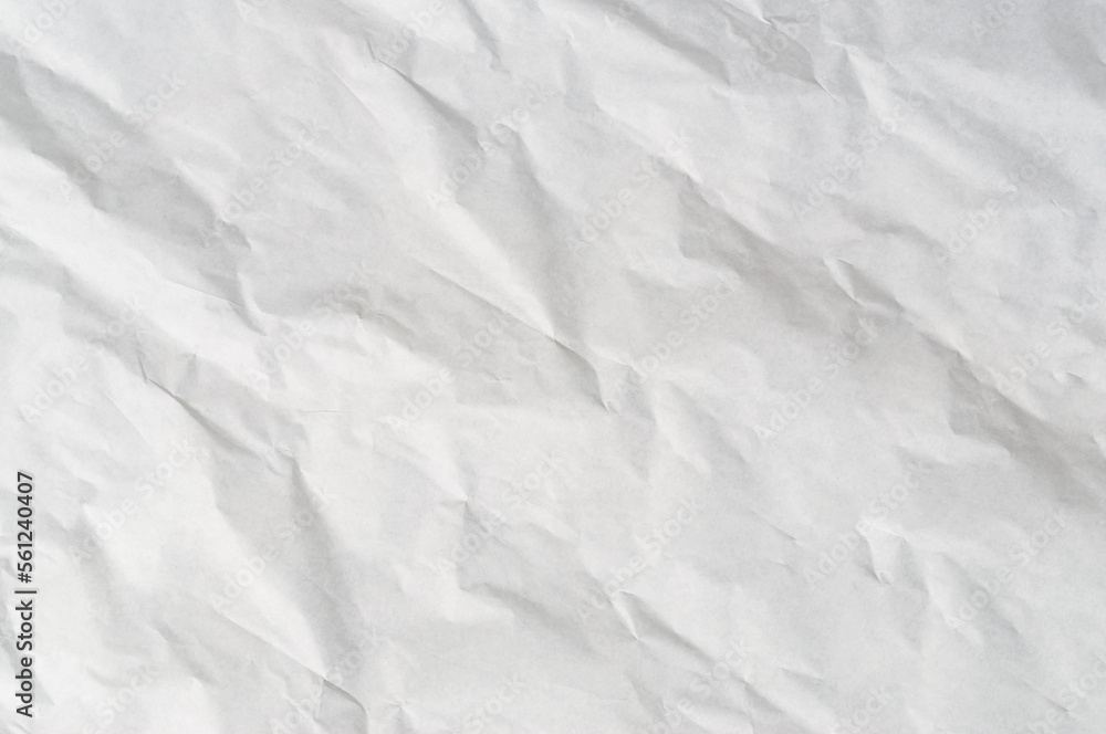 Wrinkled or crumpled white stencil paper or tissue after use in toilet or restroom with large copy space used for background texture in art work Wrinkled or crumpled white stencil paper or tissue after use in toilet or restroom with large copy space used for background texture in art work