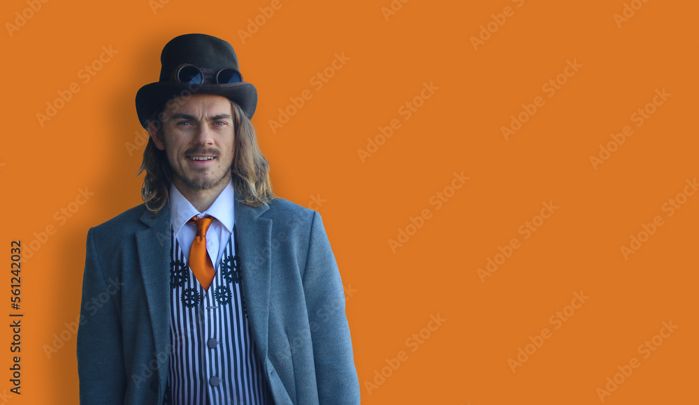 portrait of a man in suit on orange background with long hair