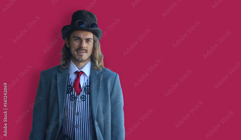 Handsome long-haired man in suit with hat