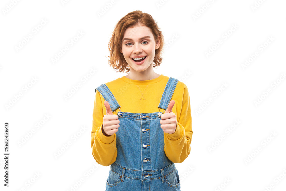 Young redhead woman shows hand with thumbs up and smiles at the camera isolated on white background Young redhead woman shows hand with thumbs up and smiles at the camera isolated on white background