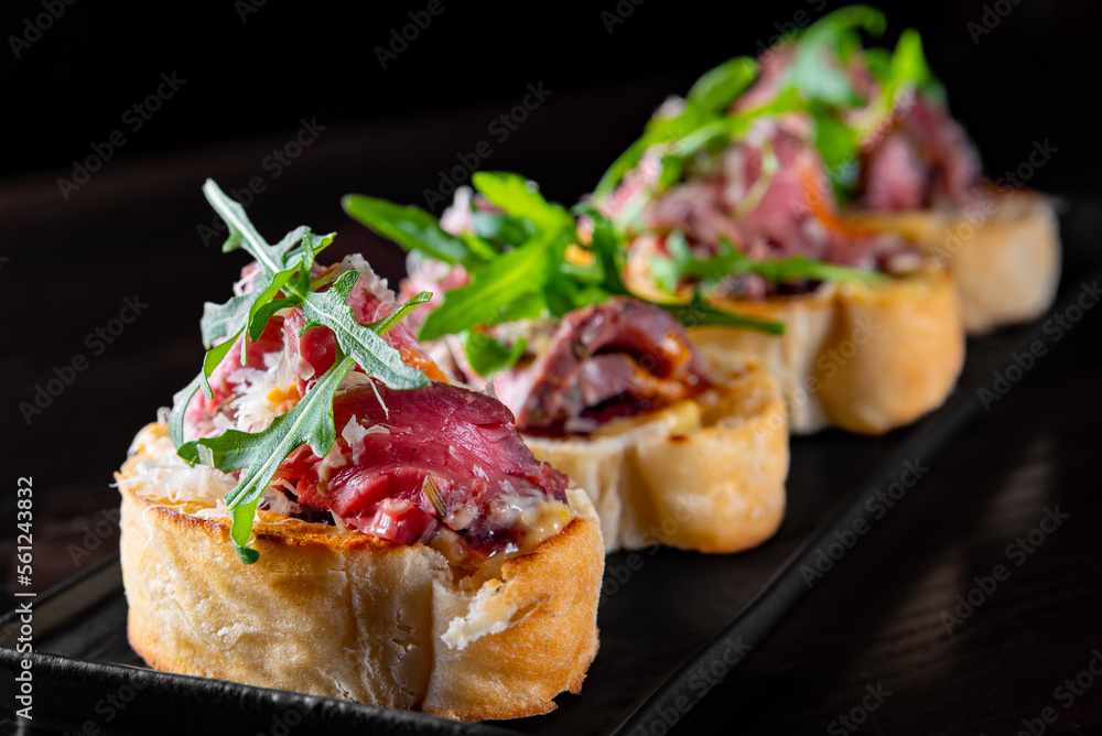 bruschetta with roast beef and cheese on plate bruschetta with roast beef and cheese on plate