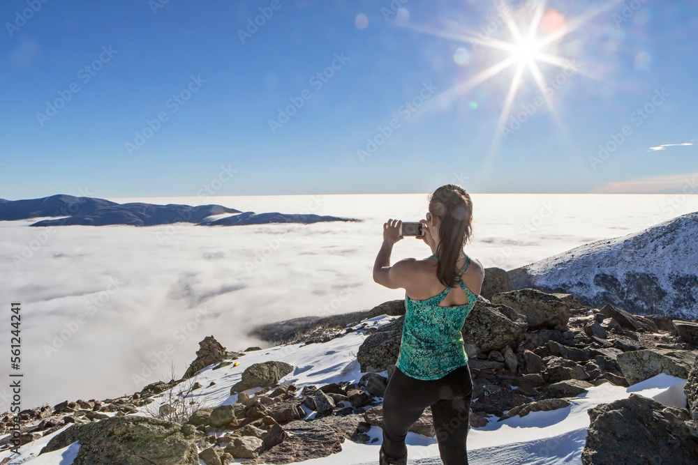 Woman on summit taking cell phone picture, Mount Washington, New Hampshire, USA Woman on summit taking cell phone picture, Mount Washington, New Hampshire, USA