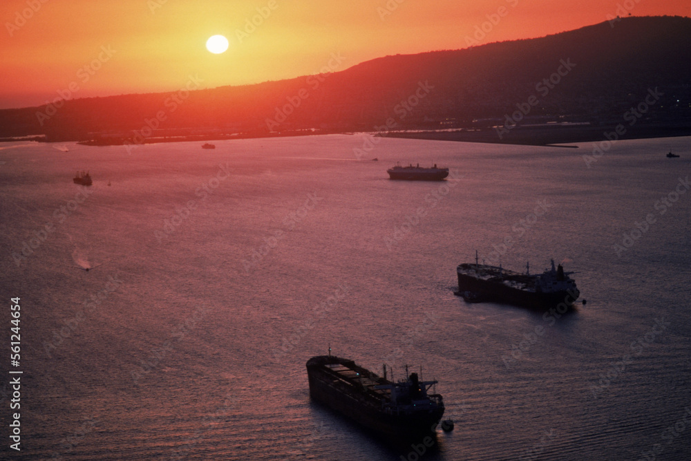 Freighters sailing into a sunset. Freighters sailing into a sunset.