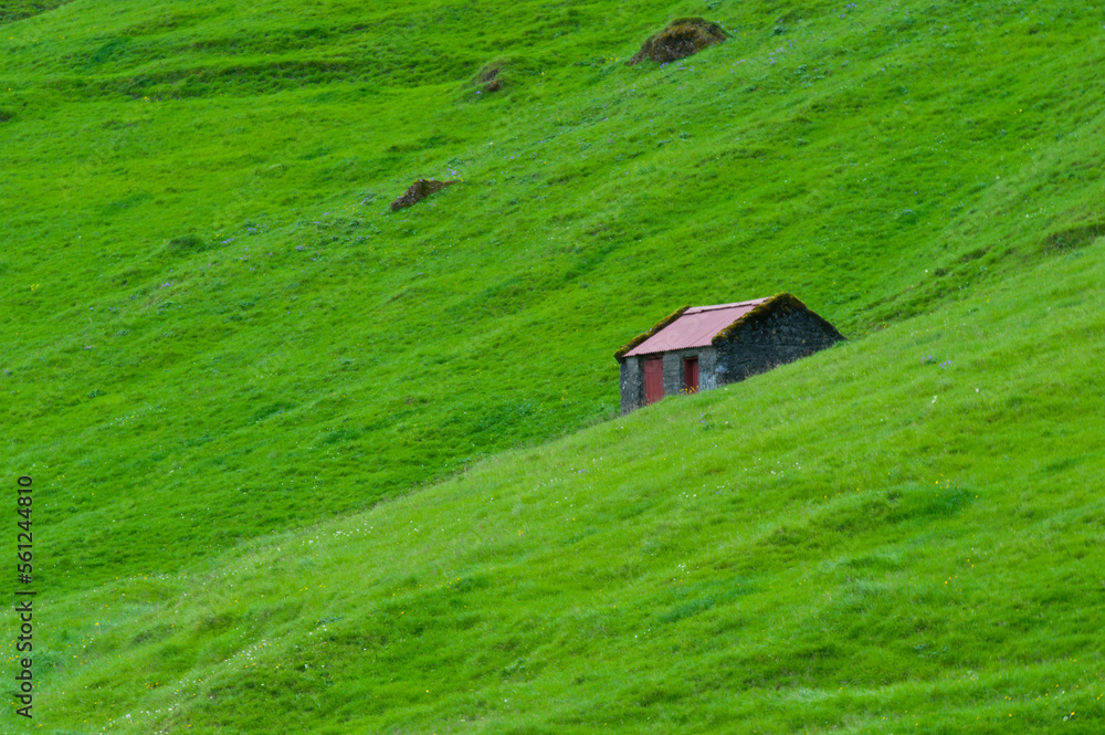 Small stone storage building on green hillside in Iceland. Small stone storage building on green hillside in Iceland.