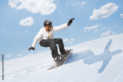 Fotografie Man gliding downhill with a snowboard