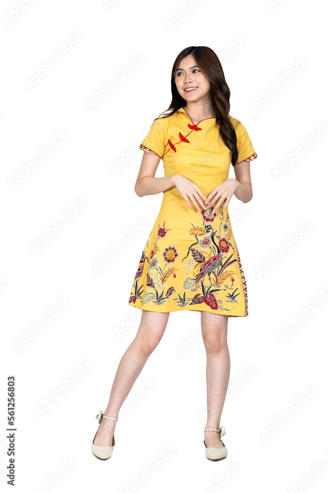 A beautiful asian woman doing a pose while wearing simple yellow chinese dress A beautiful asian woman doing a pose while wearing simple yellow chinese dress