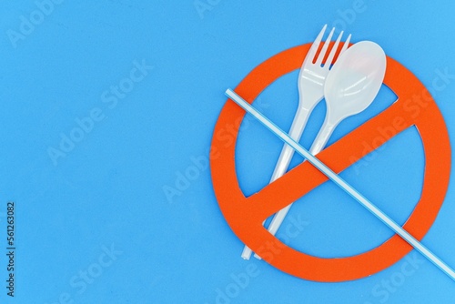 Fork and spoon on prohibition sign. Concept not to use single-use plastics. Top wiew. Copy space