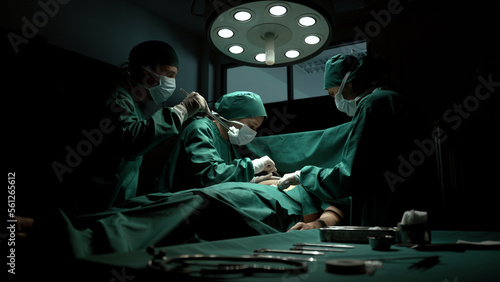Photos Medical team performing surgery in operation room.