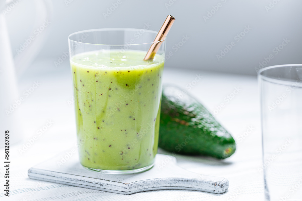 Green smoothie made from avocado and chia seeds on white background. Healthy living lifestyle. Green smoothie made from avocado and chia seeds on white background. Healthy living lifestyle.