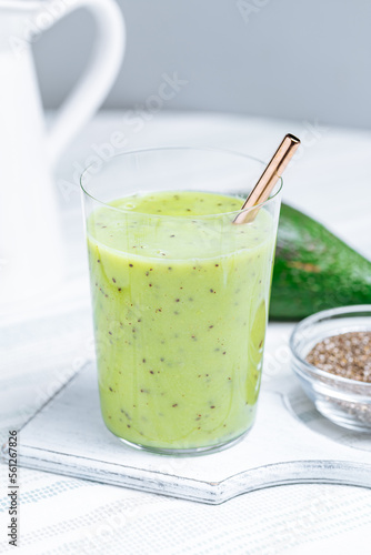 Green smoothie made from avocado and chia seeds on white background. Healthy living lifestyle. 